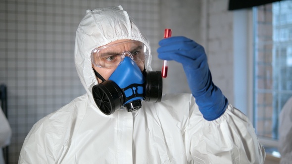 Doctor holding test tube with Positive Coronavirus test