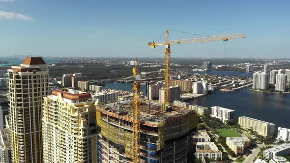 Aerial shot highrise tower under construction with cranes