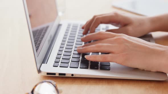 Businesswoman working over laptop at her desk