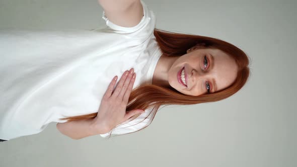 Vertical POV Portrait of Cheerful Young Woman Talking Via Video Chat Using Mobile Phone Looking at