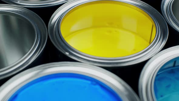 Open Multicolor Paint Cans on Grey Background, Top View