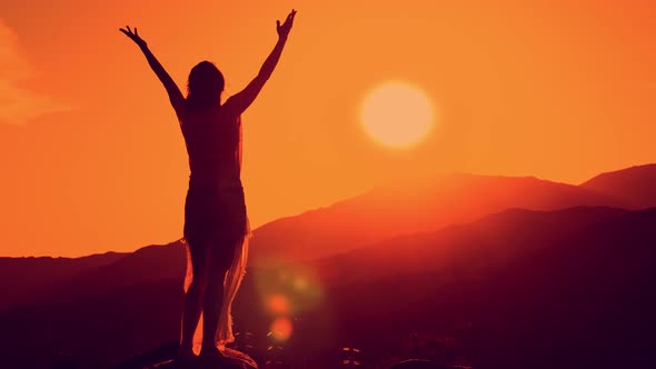 Female Silhouette on Sunset Mountain Background