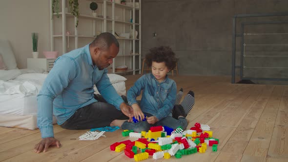 Black Father and Son Plaiyng with Building Blocks alt