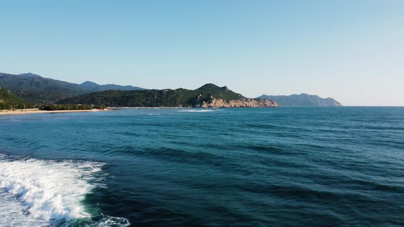 Drone fly above pristine ocean water in Vinh Hy Bay, Hang Rai majestic natural seascape mountains cl