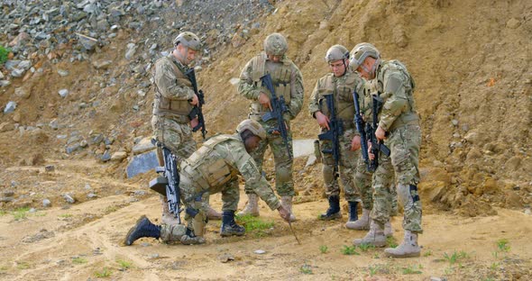 Front view of mixed-race military soldiers planing on field during military training 4k