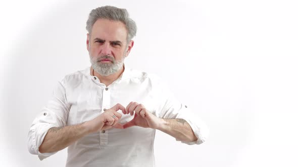 Mature Frowned Greyhaired Man Shown Heart Sing on White Background Copy Space Medium Shot