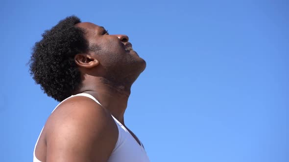 Side View of Exhausted Sportsman Wiping Sweat After Workout Outdoor