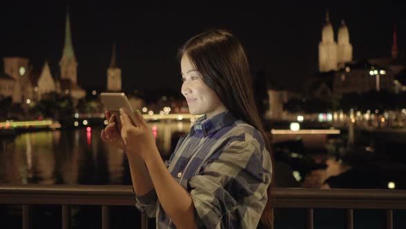 Young Asian Woman Using Digital Tablet Screen in the City alt