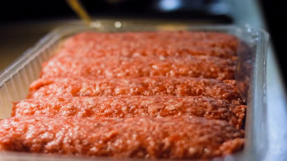 a Transparent Box with Pink Sausages