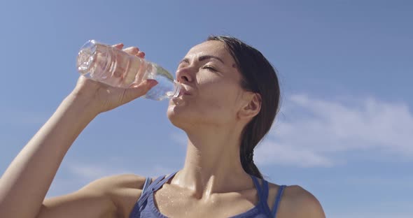 Slow Motion Shot of Sporty Trail Running Woman While Drinking Water and Resting From Intense Jogging