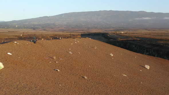 Close Up Remaining Plastic Litter Flying Wind on Landfill Hill at Sunset  USA