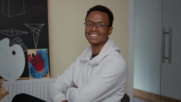 Portrait of Student Smiling and Drawing Sketch on Canvas