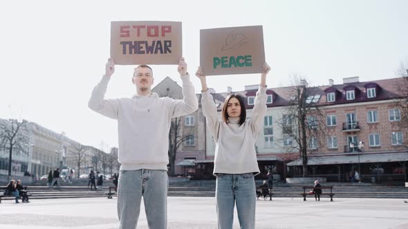 Man Holds a Poster with the Quote Stop the War