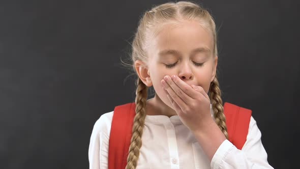 Bored Little Girl With Rucksack Yawning at Camera, Uninteresting School Lessons