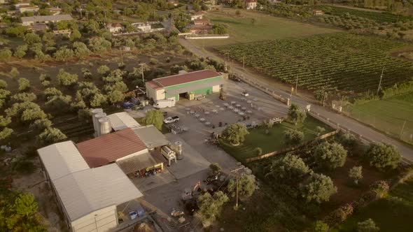 Aerial view of people preparing tables and chairs for a outdoor event in Greece.