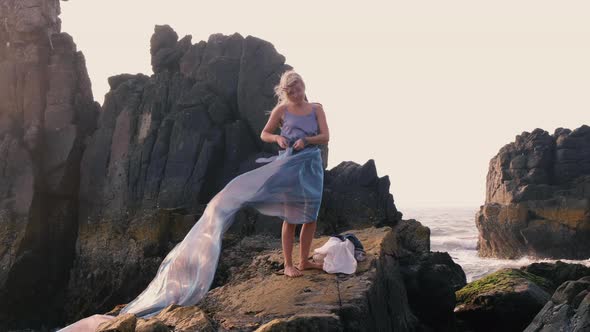 Woman enjoying a summer breeze in long dress