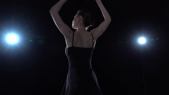 Skilled Ballerina in Black Light Dress Dancing Classical Ballet Elements. Close Up