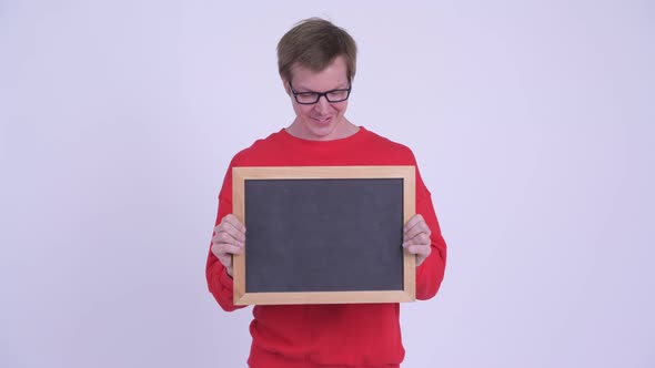 Happy Young Handsome Man Holding Blackboard