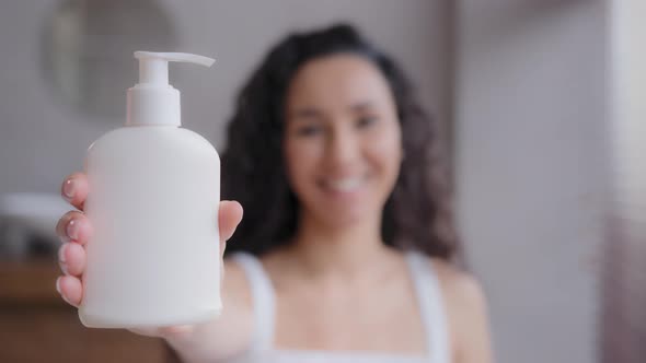 Closeup Young Attractive Happy Woman Standing in Bathroom Looking at Camera Showing Moisturizing