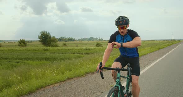 The Cyclist is Looking at the Training Data on the Fitness Tracker