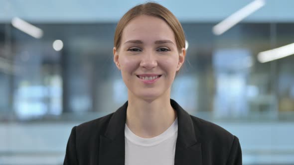 Portrait of Attractive Woman Smiling at Camera in Cafe