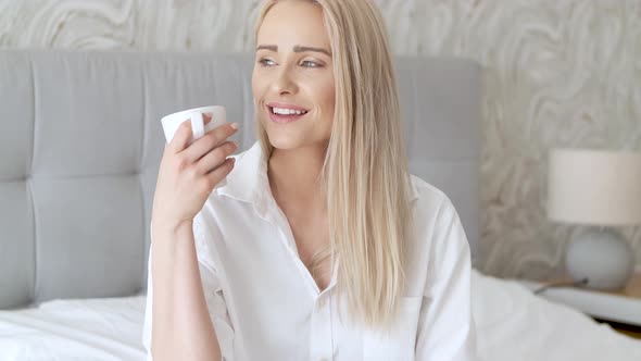 Adorable Beautiful Woman Drinks Coffee From the Mug