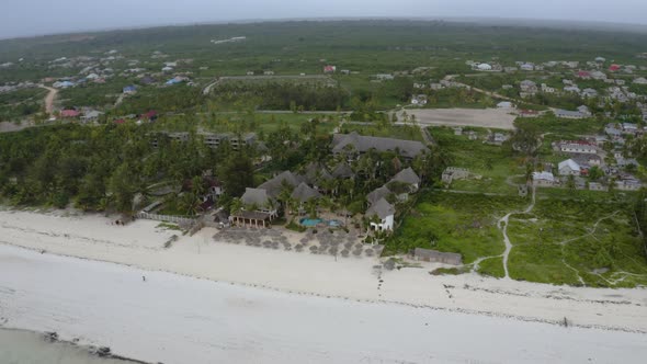 Tropical bungalow resort with white sand beaches and palm trees.