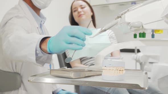 Professional Dentist Examining Teeth of a Female Patient