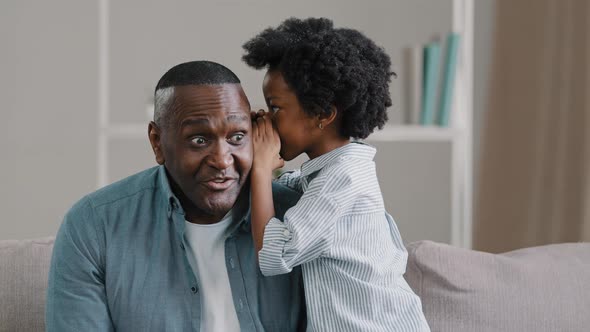 Little African American Kid Girl Shares Secret with Dad Tells Amazing Fun Story in Ear Funny Father