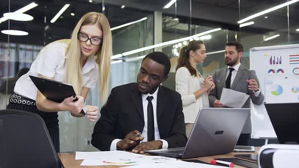 Businessman Talking with His Experienced Female Business Colleague