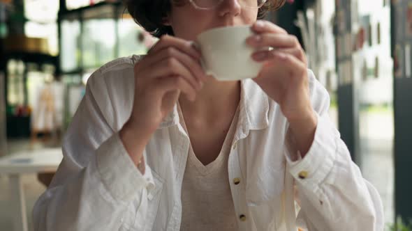 Portrait Of A Young Girl Who Drinks Coffee While Having Fun Being Alone With Thoughts, White Woman