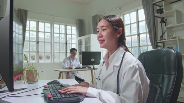 Asian Female Doctor Communicates With Patient By Video Link, Doctor Consults Patient