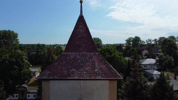 Calmer aerial view Very close passing flight drone footage of a church tower spireat Countryside vi