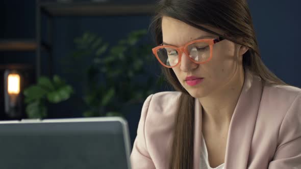 Portrait of a Middleaged Woman Working at a Laptop