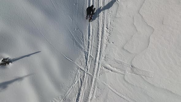 A snowboarder descends from the mountains aerial view 4 K