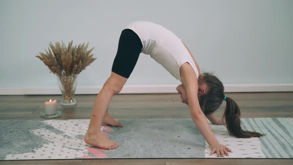 Caucasian Girl Does Yoga Child Performs Exercises on the Yoga Classes Online Yoga for Beginners