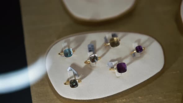 Golden Rings with Gemstones Indoors in Jewellery Store Closeup