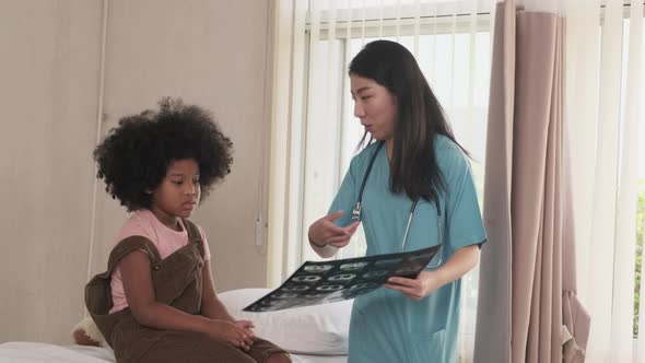 Asian female doctor health checks child at a pediatric clinic, kids hospital.