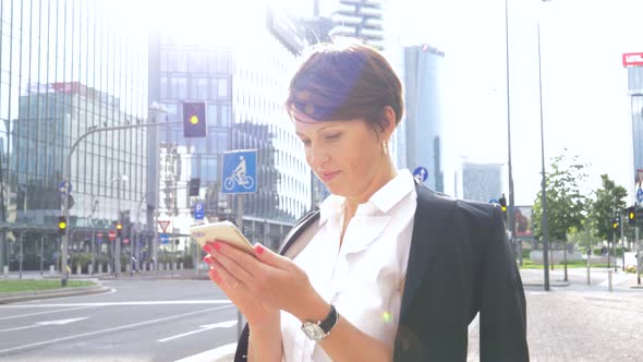 Businesswoman using smartphone in city