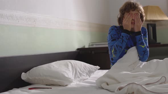 Portrait of Cute Little Boy Waking Up in the Morning with Messy Hair and Wearing Pyjama. Child Wake Up