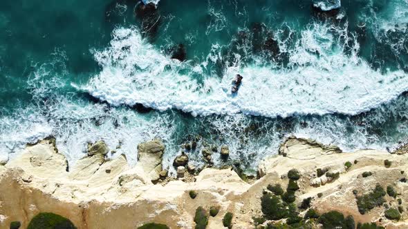Rocky Coastline Cliffside with Blue Mediterranean Sea Ocean Water at Sunny Day Cyprus