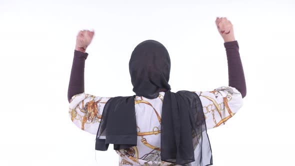 Rear View of Happy Young African Muslim Woman with Fists Raised