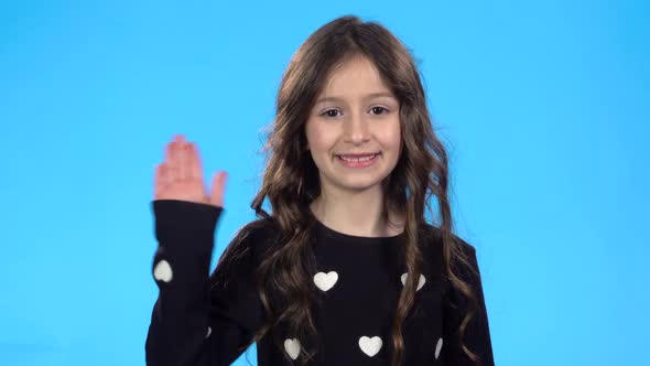 Teenager Smiling, Waving Her Hand Saying Hello, Calling Someone, Winking.