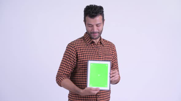 Happy Bearded Persian Hipster Man Thinking While Showing Digital Tablet