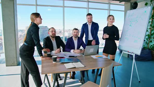 Group of happy young business people in a meeting at office