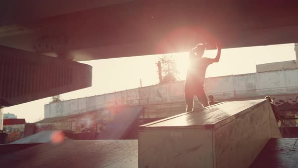 Energetic Guys Making Jump Tricks at Skate Park