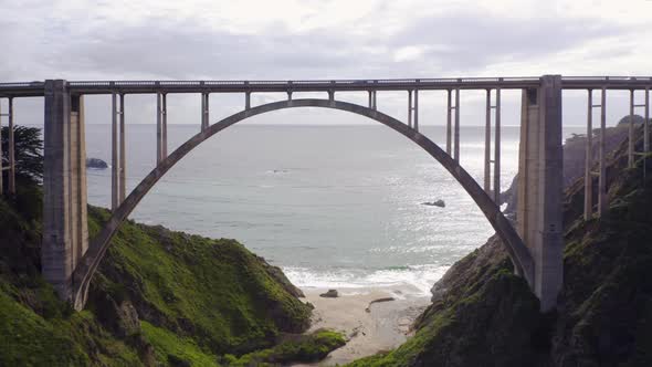 Slow Drone Flight Under the Arch of the Beautiful Bixby Creek Bridge Towards the Ocean