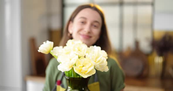 Woman Decorates Home Interior with a Bouquet of Fresh Flowers