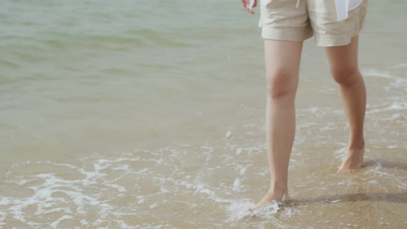 Caucasian female happiness walking on the beach on a holiday weekend.