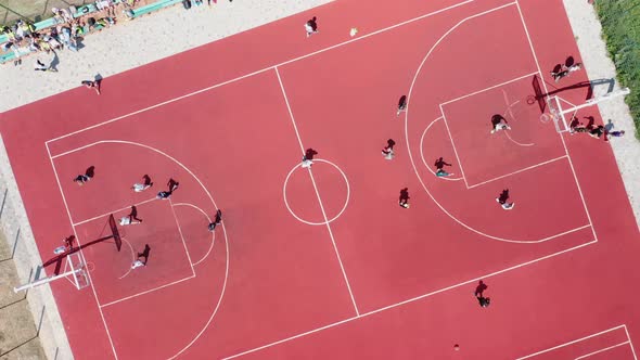 Aerial View of Young Athletes Playing Streetball on an Outdoor Public Basketball Court